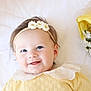 Elizabeth is registered to the contest to win money with this photo: baby, smiling, headband, flower, yellow_clothing, lace_collar, lying_down, white_background, bouquet, white_flowers, yellow_wrapping, cute, portrait, infant, happy, child, close_up, face, soft_lighting, adorable