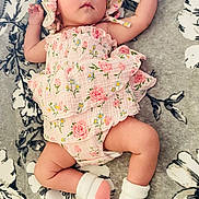 Michaela Rayne joined the competition — help win amazing prizes! arms_raised, baby, blanket, bonnet, bottle, child, floral_blanket, floral_outfit, full_body, indoor, infant, lying_down, nursery, peaceful, pink_clothing, portrait, sleepy, socks, text_overlay, two_months_old