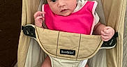 Michaela Rayne is registered to the contest to win money with this photo: baby, baby_clothing, beige, bouncer, child, eyes, face, feet, floor, furniture, high_chair, indoor, infant, legs, photography, pink_bib, portrait, rug, sitting, wide_eyed