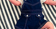 Michaela Rayne is registered to the contest to win money with this photo: arms, baby, blanket, child, close_up, cute, denim, face, fashion, happy, indoor, infant, legs, lying_down, overalls, photography, portrait, shirt, smiling, striped_blanket