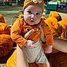 baby, child, pumpkin, halloween, costume, orange, headband, flower, infant, outdoor, night, portrait, cute, wide_eyed, being_held, arms, fall, autumn, farm, festive