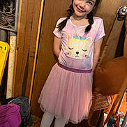 Brooklynne joined the competition — help win amazing prizes! bag, braids, casual, cat_print, child, clutter, cute, floor, girl, happy, indoor, person, pink_dress, portrait, smiling, sneakers, standing, white_leggings, wooden_door, young