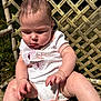baby, child, infant, onesie, polka_dot, butterfly, hands, legs, outdoor, sunlight, chair, woven_chair, curious, cute, sitting, grass, skin, daylight, closeup, portrait