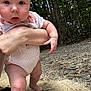 Eliza is registered to the contest to win money with this photo: baby, child, infant, outdoor, forest, trees, dirt_path, person, arm, legs, onesie, pink, polka_dot, curious, expression, skin, footwear, nature, daylight, holding