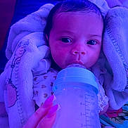 Royalty joined the competition — help win amazing prizes! baby, bottle, feeding, blanket, hand, nails, infant, milk, clothing, face, portrait, sleepwear, soft_texture, closeup, indoor, cute, newborn, resting, comfort, warmth