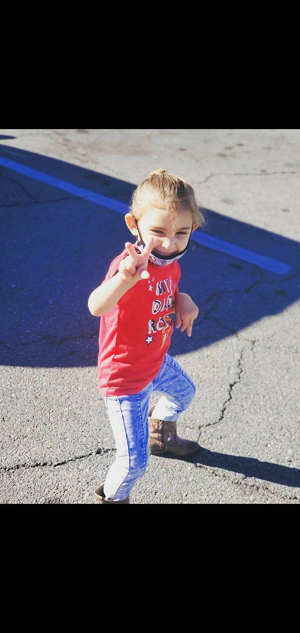 Noelle is registered to the contest to win money with this photo: asphalt, cool, denim, electric_blue, eyewear, fun, gesture, grass, happy, human_leg, leisure, mammal, person, recreation, sleeve, sportswear, standing, t_shirt, tints_and_shades, toddler