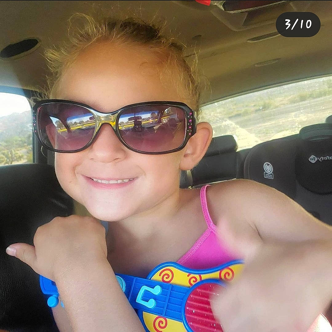 Noelle is registered to the contest to win money with this photo: arm, automotive_exterior, black_hair, cool, eye_glass_accessory, eyewear, finger, glasses, goggles, hand, happy, joy, lip, mouth, muscle, neck, person, smile, sunglasses, vehicle_door