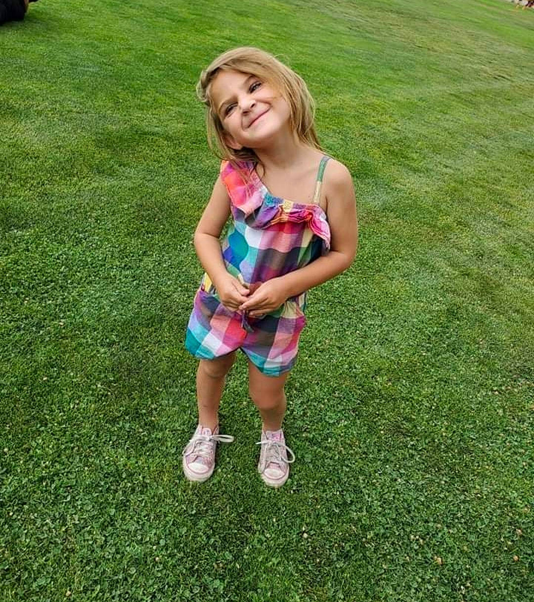 Noelle joined the competition — help win amazing prizes! baby_toddler_clothing, blond, facial_expression, fun, grass, grassland, hairstyle, happy, joy, knee, lawn, leisure, meadow, people_in_nature, person, recreation, shorts, smile, summer, t_shirt