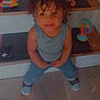 Kamran is registered to the contest to win money with this photo: casual_clothing, child, colorful_toys, curly_hair, cute, happy, home, indoor, looking_up, person, playful, sitting, smile, sneakers, stairs, toddler, toy, wooden_floor, wooden_stairs, young_child