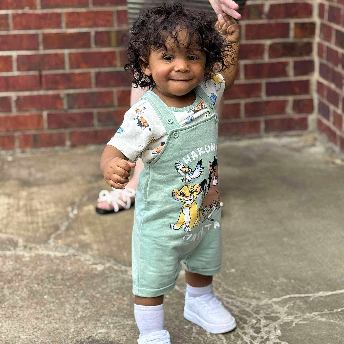 Kamran joined the competition — help win amazing prizes! baby, brick_wall, casual, child, concrete, curly_hair, cute, fashion, footwear, hakuna_matata, hand_holding, outdoor, overalls, person, smile, socks, support, toddler, walking, white_sneakers