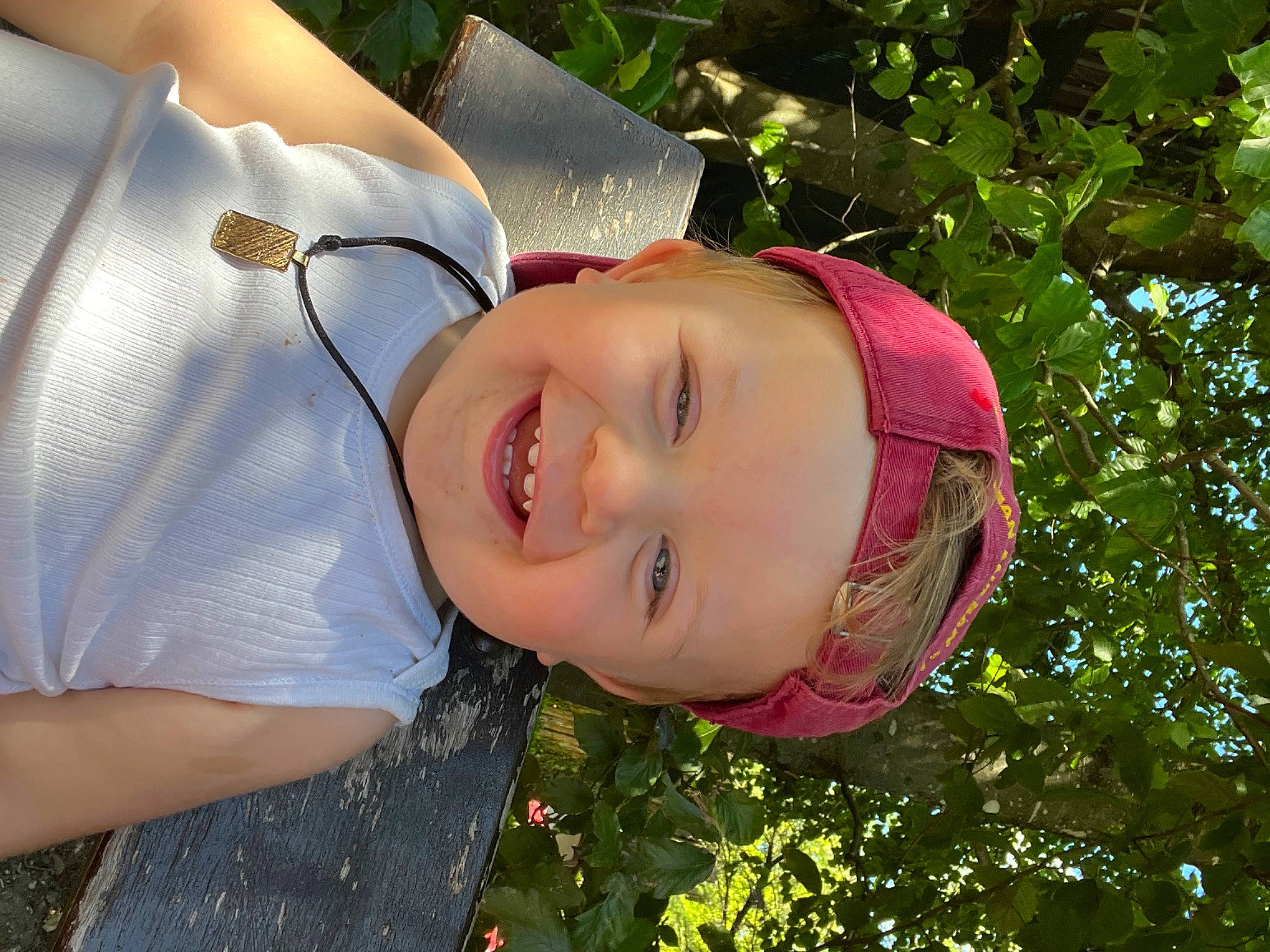 Raphaël participe au concours pour gagner de l'argent avec cette photo : child, chin, eye, face, fun, grass, happy, hat, head, headgear, headwear, human_body, joy, leisure, lip, mouth, nose, people_in_nature, person, plant