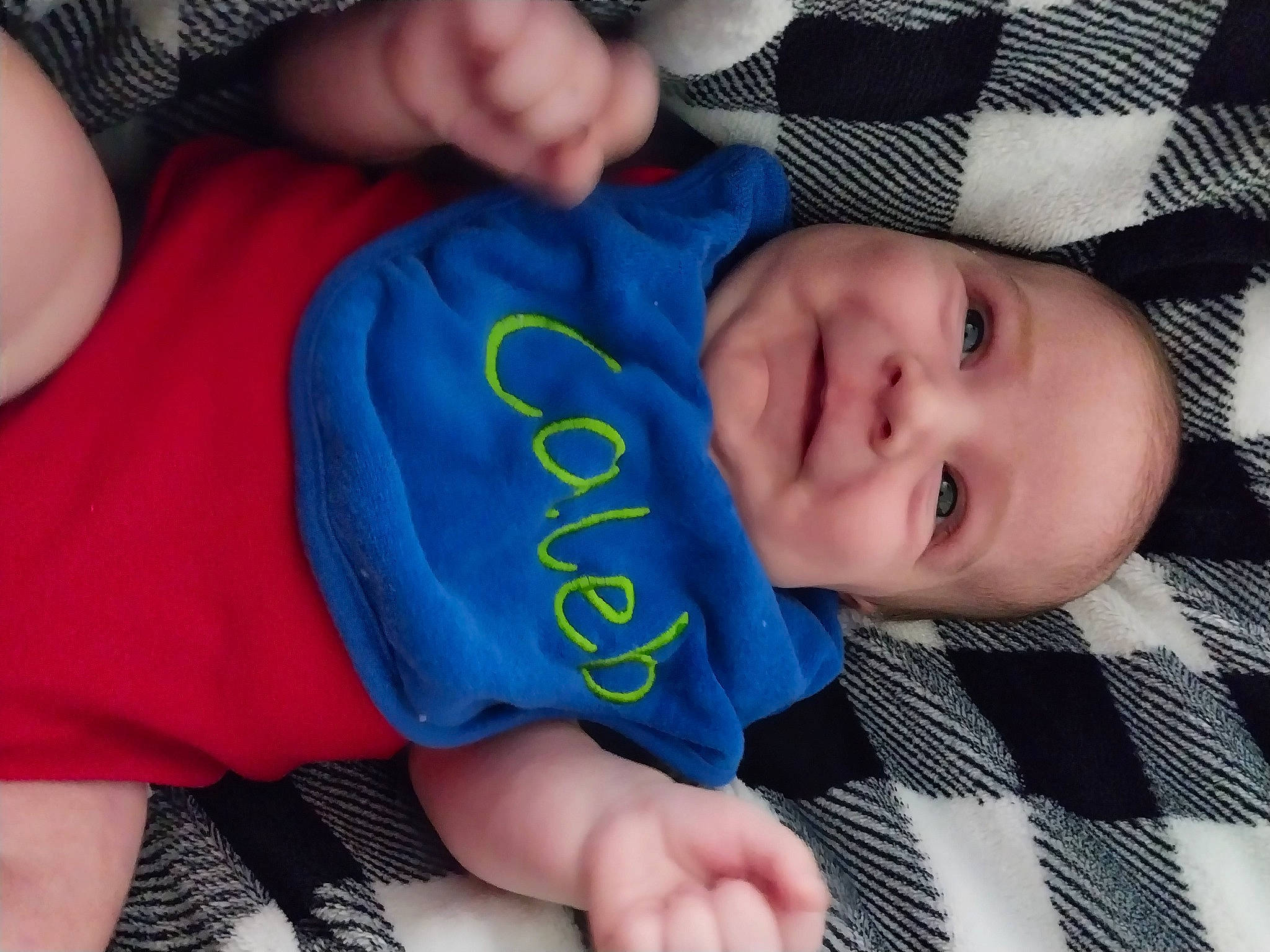 Caleb is registered to the contest to win money with this photo: baby, baby_toddler_clothing, blue, cheek, child, chin, comfort, finger, gesture, hand, human_body, joy, mouth, nail, nose, person, skin, sleeve, smile, textile