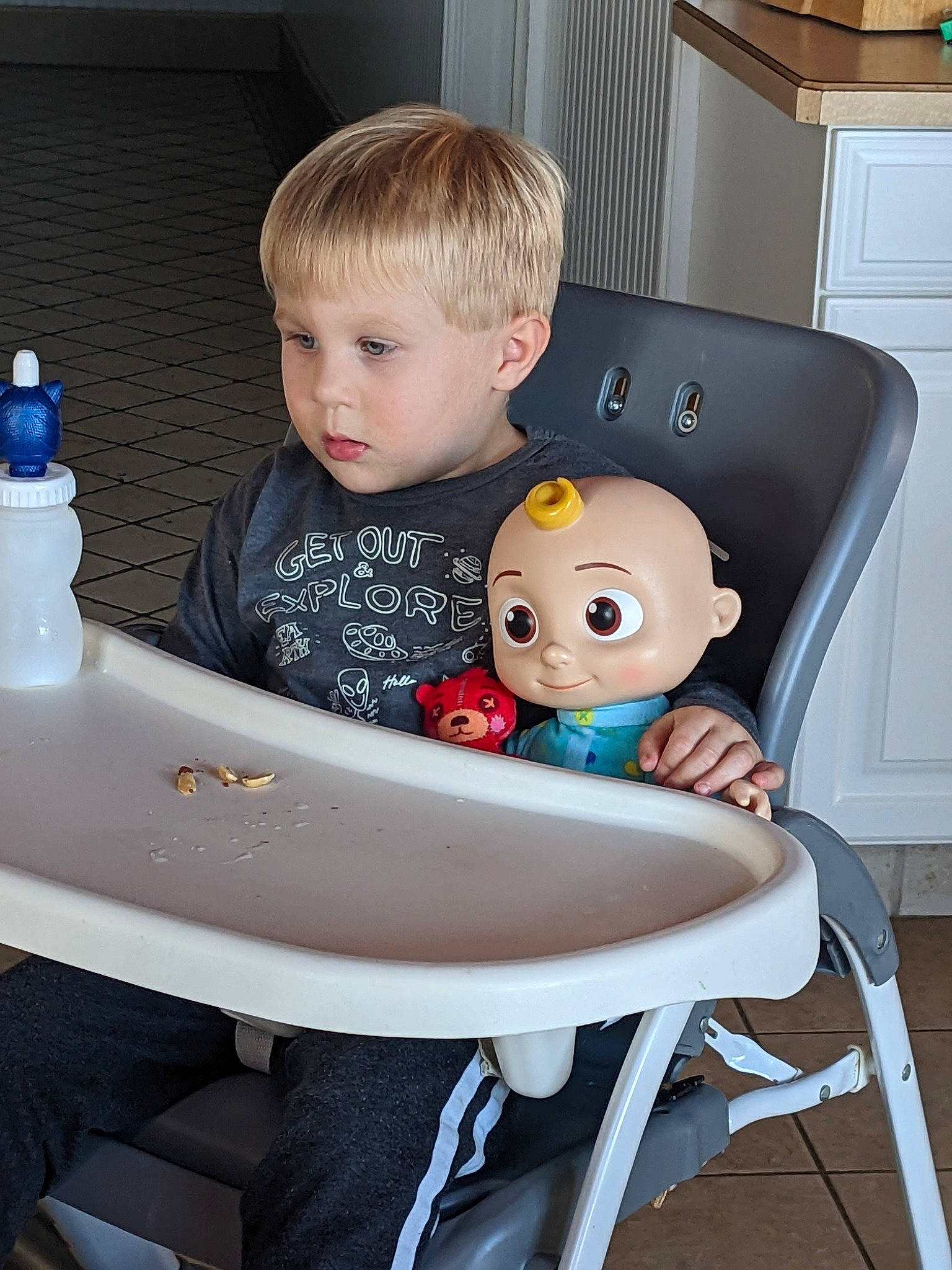 Jaxson is registered to the contest to win money with this photo: baby, baby_products, chair, child, comfort, desk, drawer, fun, hairstyle, office_equipment, person, plastic, plastic_bottle, play, room, sitting, t_shirt, table, toddler, toy