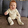 baby, child, clothing, couch, cozy, cushions, cute, furniture, happy, home, indoor, infant, light, pajamas, person, portrait, red_hair, sitting, smiling, soft_texture
