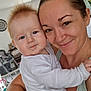 Alexis participe au concours pour gagner de l'argent avec cette photo : arm, baby, bottle, child, clothing, face, family, furniture, hair, happy, head, highchair, holding, home, indoor, kitchen, person, skin, smile, woman