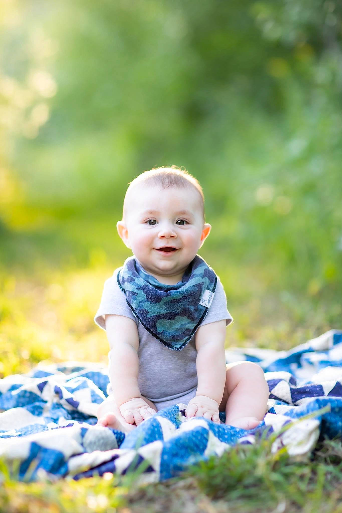 Tanner is registered to the contest to win money with this photo: baby, baby_toddler_clothing, child, electric_blue, flash_photography, fun, grass, happy, joy, laugh, leisure, people_in_nature, person, plant, portrait, portrait_photography, sitting, smile, sunlight, toddler