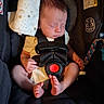 newborn, baby, car_seat, sleeping, infant, blanket, straps, foot, hand, face, child, safety, rest, indoors, cute, peaceful, young, person, clothing, seat