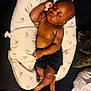 baby, bed, blanket, child, comfort, cushion, cute, dark_skin, human, indoors, infant, peace, peaceful, person, pillow, relaxation, rest, shorts, sleep, sleeping