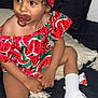toddler, child, pacifier, watermelon_pattern, headband, curly_hair, white_socks, white_sandals, couch, pillow, indoor, clothing, sitting, cute, small_child, person, fashion, accessory, colorful, portrait