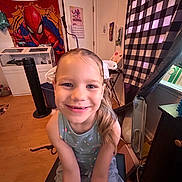 Bella joined the competition — help win amazing prizes! child, girl, smiling, indoor, room, spiderman, tapestry, curtain, furniture, chair, calendar, floor, window, hair, clothing, decorations, fan, table, light, portrait