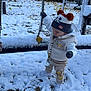 baby, cap, car, clothing, face, footwear, glove, hat, head, machine, nature, outdoors, person, shoe, snow, toy, transportation, vehicle, wheel, winter