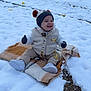 baby, bonnet, cap, clothing, face, footwear, glove, hat, head, hood, knitwear, nature, outdoors, pants, person, plant, shoe, snow, sweater, tree