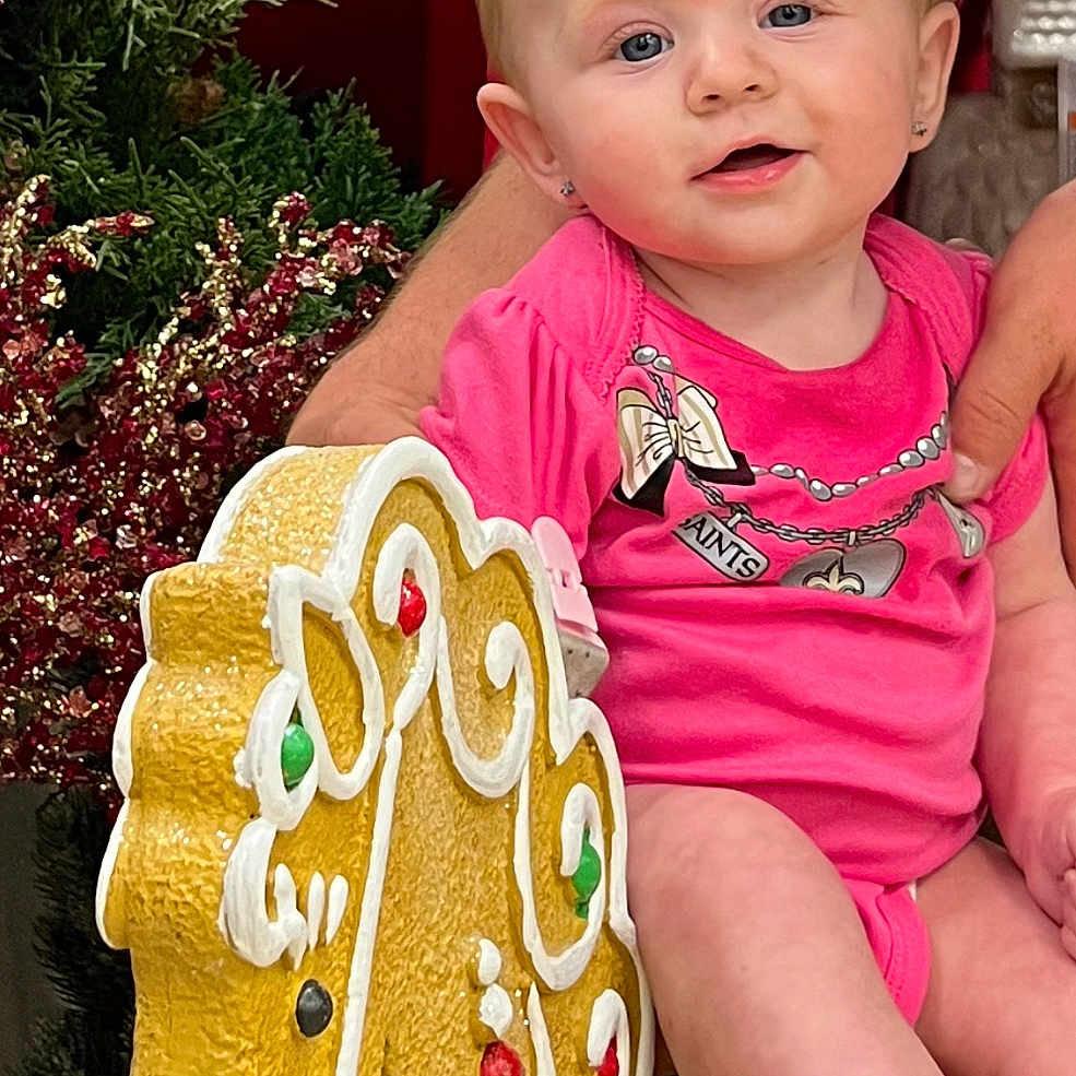 Zarina is registered to the contest to win money with this photo: baby, birthdaycake, bodypart, cake, cookie, couch, cream, dessert, face, finger, food, furniture, gingerbread, hand, head, icing, person, photography, portrait, sweets