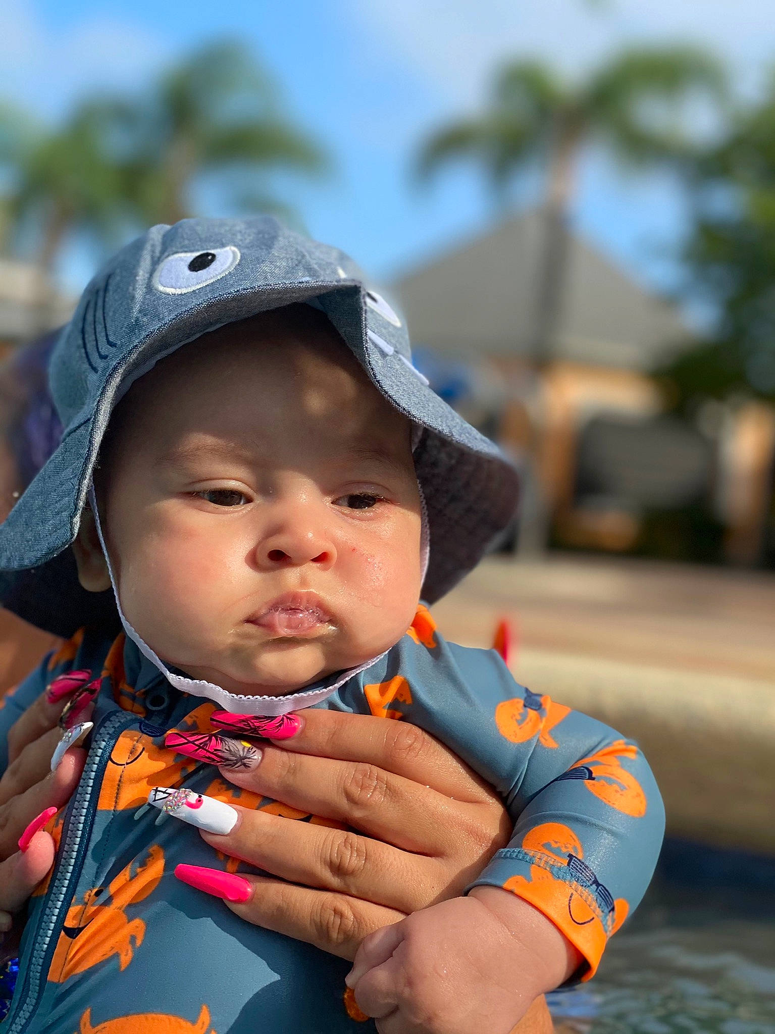 Martin is registered to the contest to win money with this photo: baby, cap, child, fashion_accessory, fun, hand, happy, hat, headwear, leisure, lip, person, personal_protective_equipment, recreation, sitting, skin, sky, toddler, tourism, travel