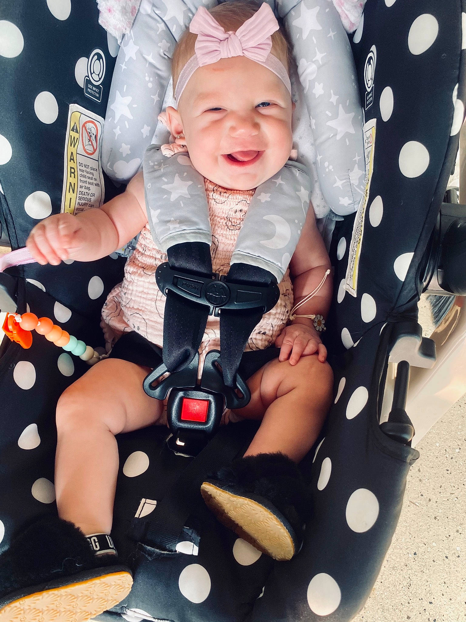 Camila is registered to the contest to win money with this photo: baby, baby_products, baby_toddler_clothing, child, eye, face, finger, flash_photography, fun, gesture, happy, headwear, joy, pattern, person, pink, product, sitting, sleeve, smile