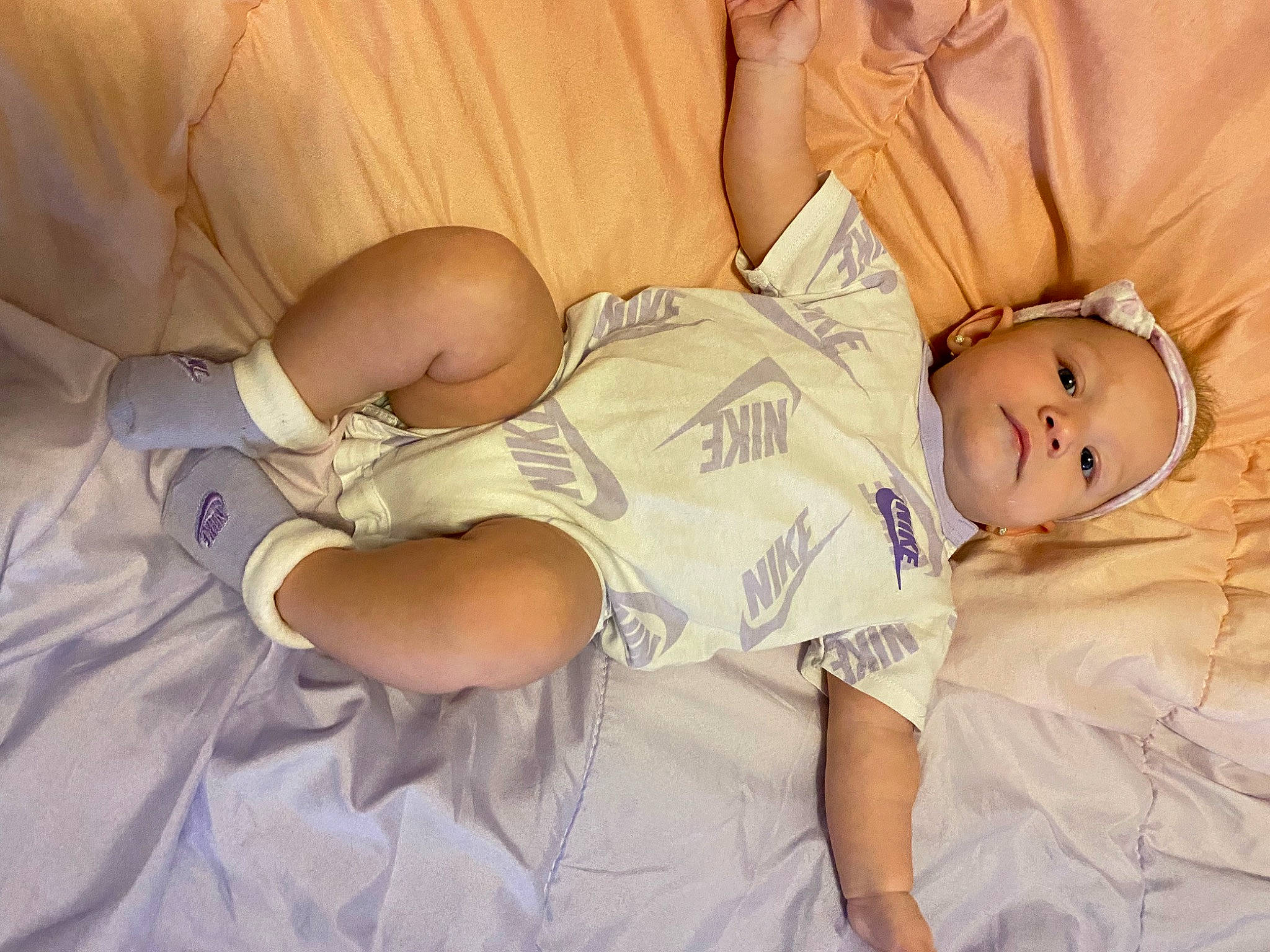 Camila is registered to the contest to win money with this photo: abdomen, baby, baby_toddler_clothing, bed, bedtime, child, comfort, elbow, finger, happy, hat, human_leg, knee, linens, person, skin, t_shirt, textile, thigh, toddler