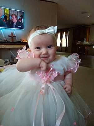 Tara is registered to the contest to win money with this photo: baby, ballet_tutu, cheek, child, clothing, costume, dress, eye, fun, joy, person, pink, skin, smile, thumb, toddler