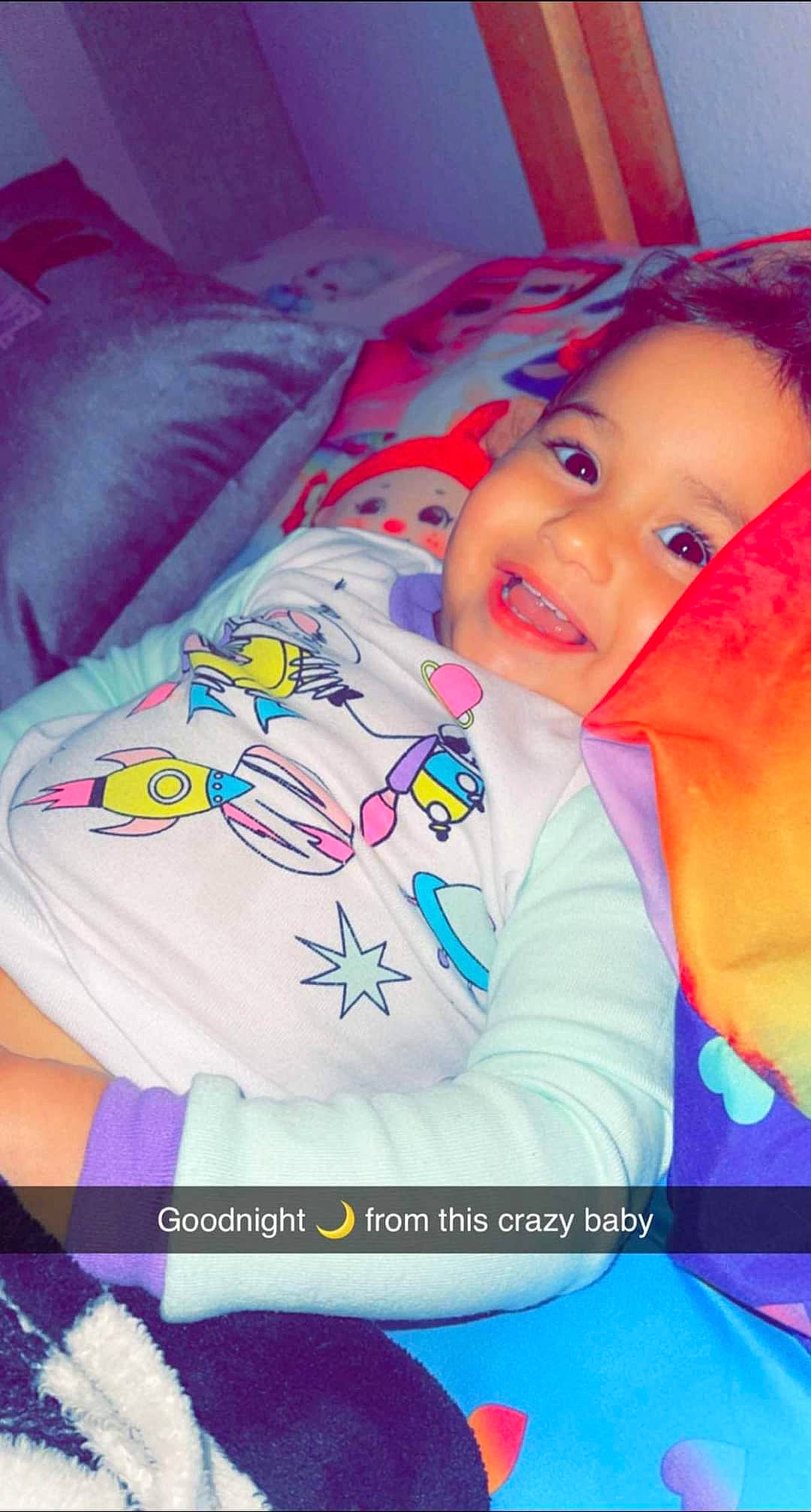 Zah'Kariah joined the competition — help win amazing prizes! baby, baby_laughing, baby_products, baby_toddler_clothing, child, comfort, electric_blue, facial_expression, font, happy, linens, magenta, pattern, person, pink, purple, sleeve, smile, t_shirt, textile