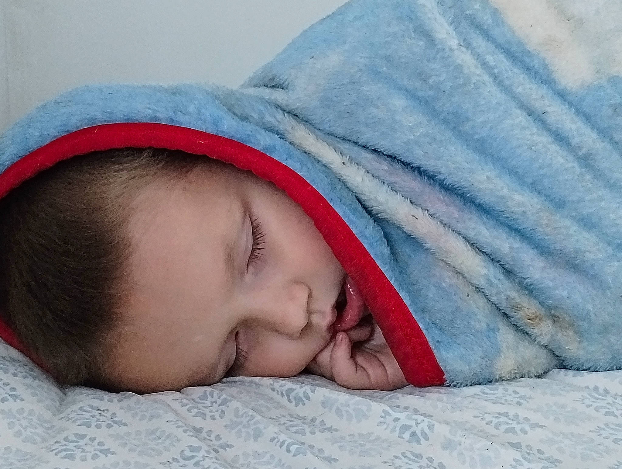 James is registered to the contest to win money with this photo: baby, baby_sleeping, bedding, bedtime, cheek, child, comfort, electric_blue, eye, eyebrow, face, happy, head, headgear, linens, lip, nose, person, skin, sleeve