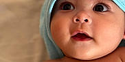 Isaac participe au concours pour gagner de l'argent avec cette photo : baby, infant, face, eyes, skin, towel, blue_towel, expression, curious, closeup, portrait, child, cute, soft, hood, indoors, newborn, headwear, bare_chest, adorable