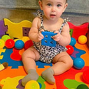 Emerald joined the competition — help win amazing prizes! baby, child, toy, playmat, ball, colorful, indoor, sitting, cute, infant, puzzle_mat, sock, clothing, face, hands, person, hair_bow, plastic_ball, floor, playtime