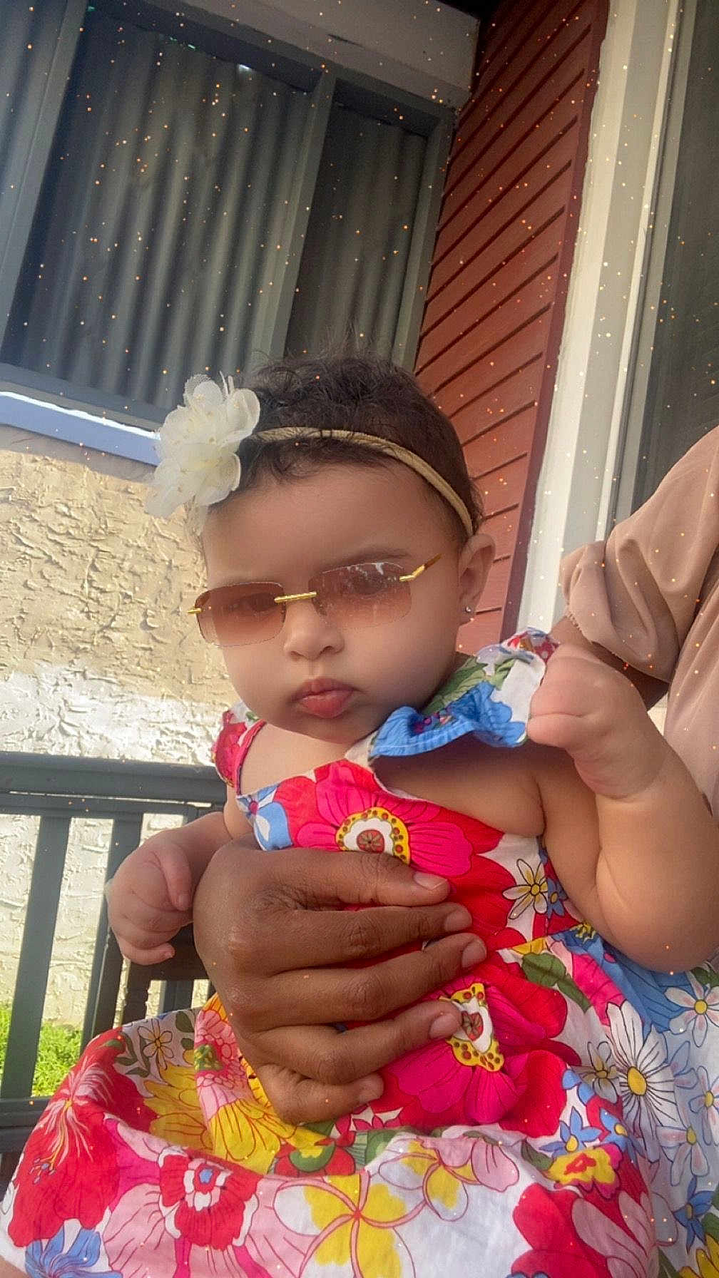 Shantalys joined the competition — help win amazing prizes! baby, child, sunglasses, flower_headband, floral_dress, hand, person, outdoor, porch, railing, window, curtain, skin, fashion, cute, summer, colorful, accessory, holding, portrait