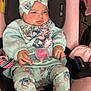 baby, child, car_seat, pink, pastel, pajamas, headband, pacifier, clothing, socks, cute, indoor, infant, seat_belt, toy, fabric, comfort, portrait, young_child, cartoon_print