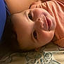 Shantalys is registered to the contest to win money with this photo: baby, smiling, infant, face, closeup, blanket, pattern, drool, peach_clothing, lying_down, human, skin, arm, bed, comfort, cute, happy, child, portrait, indoors