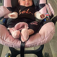Shantalys is registered to the contest to win money with this photo: baby, infant, stroller, pink, hat, booties, clothing, black_outfit, flooring, wood_floor, wheels, indoor, child, cute, seat, car_seat, headwear, footwear, person, baby_girl