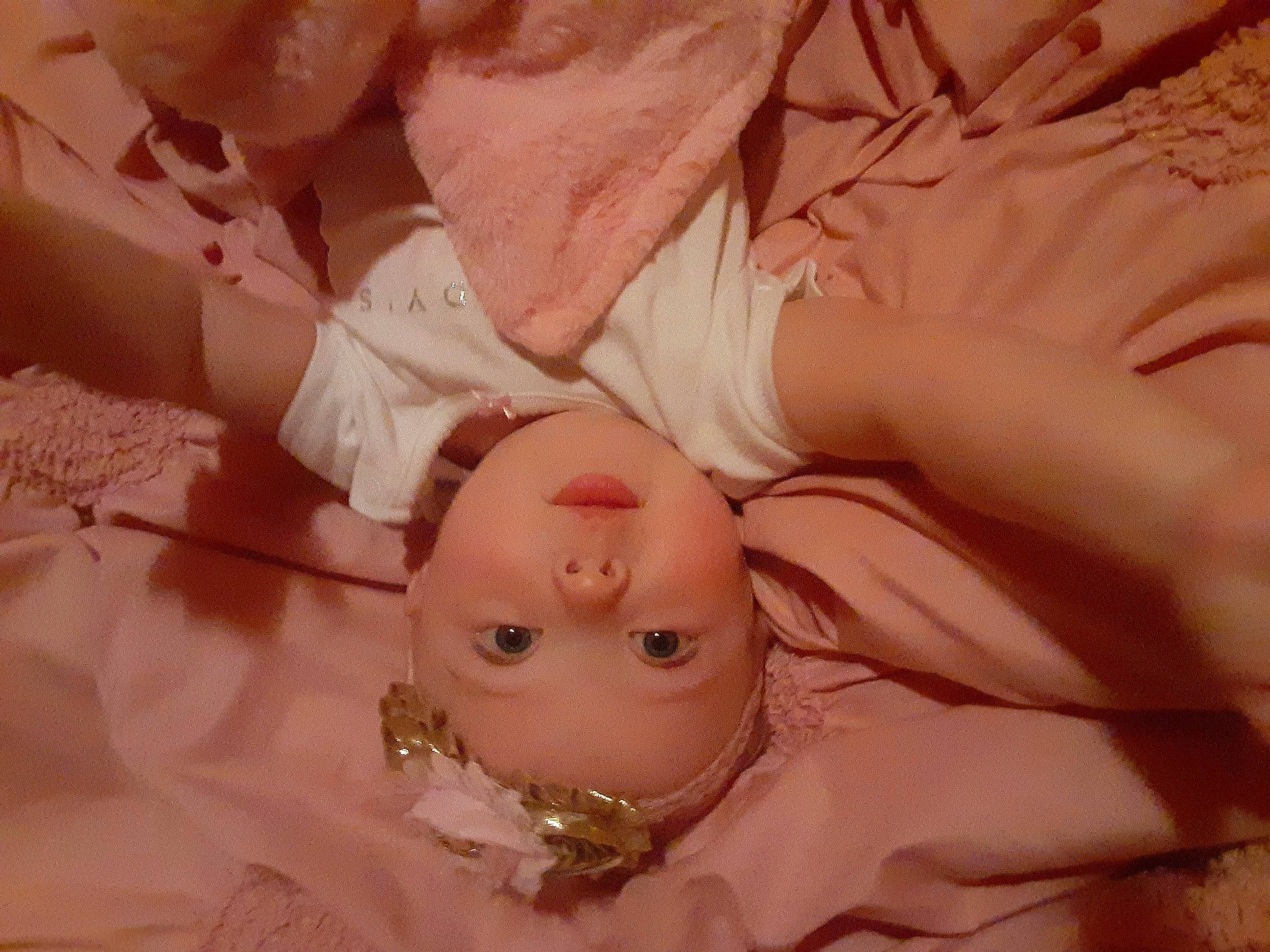 Diana is registered to the contest to win money with this photo: baby, cheek, chin, clothing, eye, eyebrow, eyelash, finger, hair, hand, head, headgear, human_body, jewellery, lip, mouth, person, pink, skin, textile