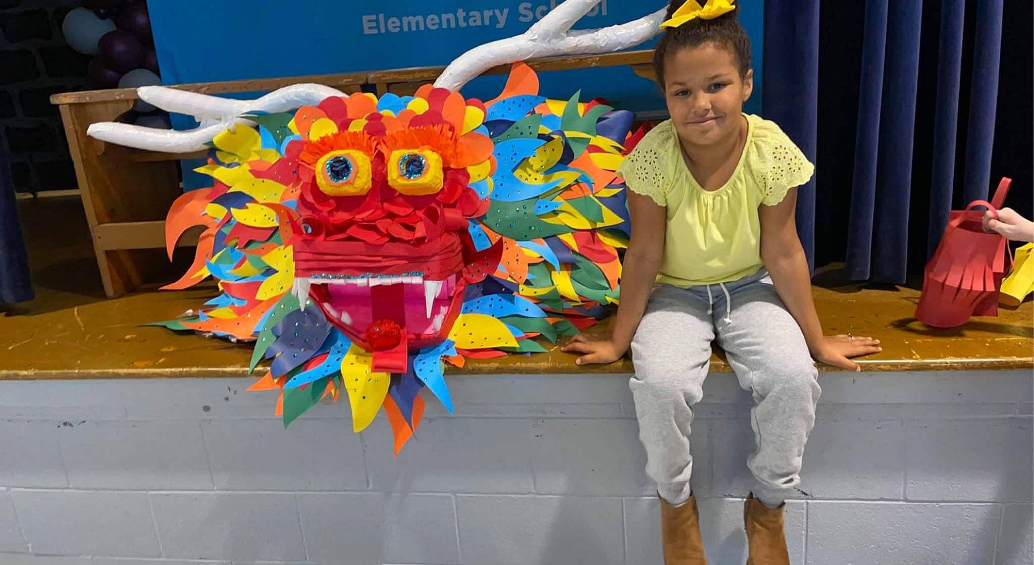 Alaysia is registered to the contest to win money with this photo: animation, art, artist, child, costume, entertainment, event, fun, joy, leisure, paper_product, party_supply, person, play, recreation, room, sitting, smile, t_shirt, toddler