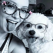 Chance Donald joined the competition — help win amazing prizes! bow, companion, cute, dog, eyewear, face, glasses, hair_bun, happy, human, indoor, pet, playful, portrait, selfie, smiling, tank_top, tongue_out, white_dog, woman
