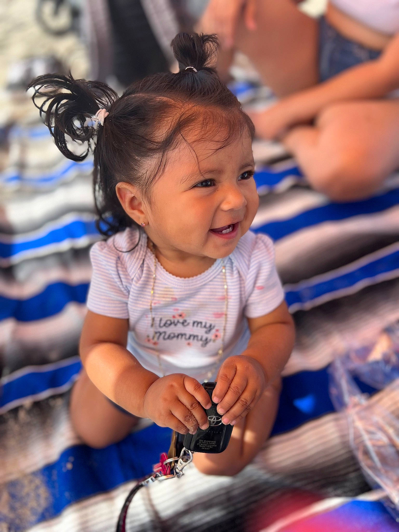 Anais is registered to the contest to win money with this photo: baby, blue, child, electric_blue, event, facial_expression, fun, happy, human, leisure, person, play, recreation, sitting, skin, smile, snapshot, t_shirt, toddler, tradition