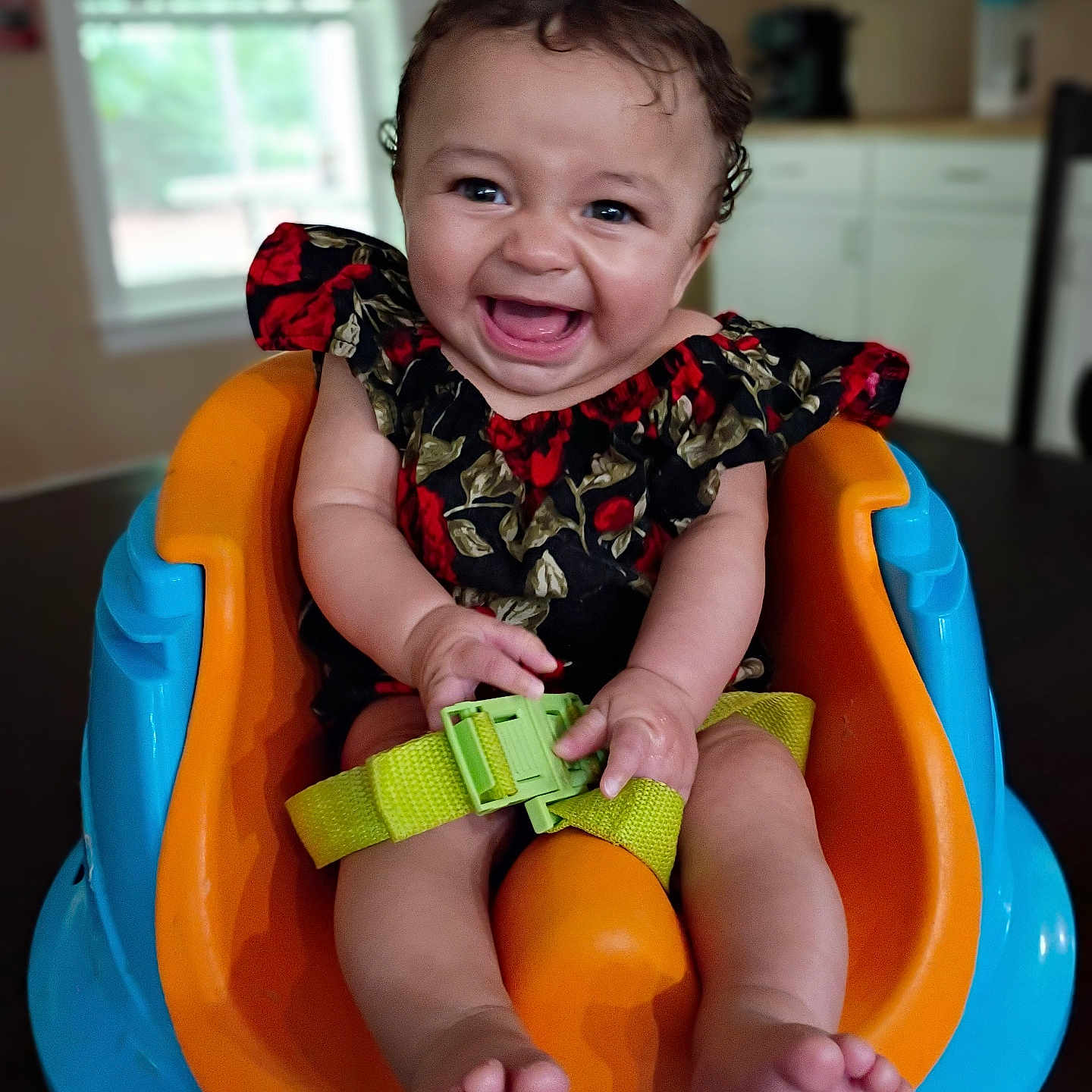 O'Dyssey is registered to the contest to win money with this photo: baby, child, smile, happy, infant, seat, safety_belt, colorful, indoors, kitchen, person, cute, face, furniture, clothing, joy, sitting, toy, bright_colors, expression