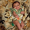 O'Dyssey joined the competition — help win amazing prizes! baby, infant, smile, green_clothing, floral_dress, blanket, cat_prints, pattern, cute, lying_down, happy, child, footwear, boots, indoors, portrait, skin, face, eyes, hands