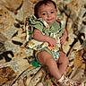 O'Dyssey is registered to the contest to win money with this photo: baby, infant, child, blanket, cat_pattern, clothing, footwear, socks, smile, face, portrait, cute, indoor, fabric, pattern, comfort, relaxation, person, baby_shoes, happy