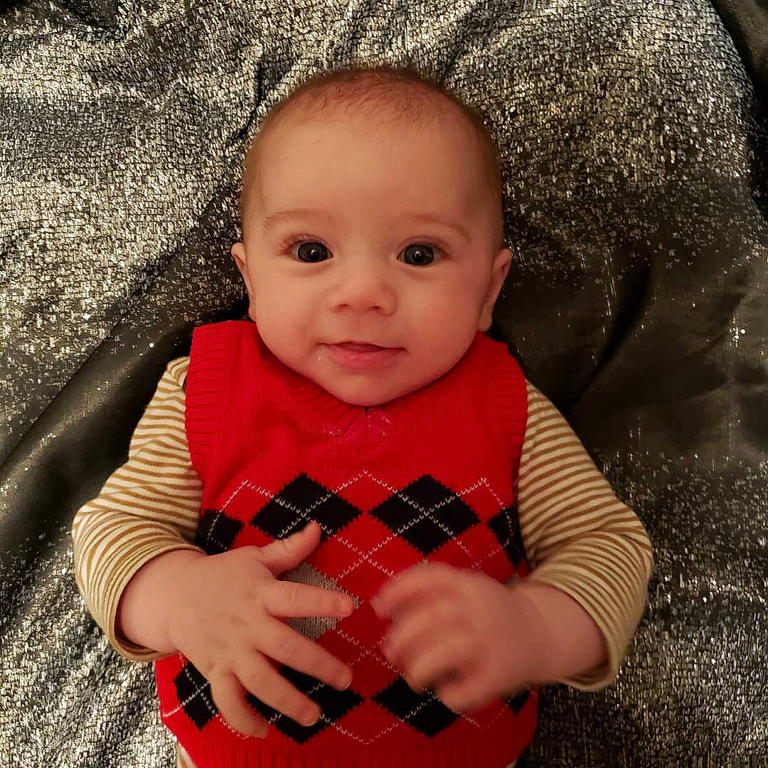 Loki is registered to the contest to win money with this photo: baby, baby_products, baby_toddler_clothing, cheek, child, hand, lip, overall, pattern, person, plaid, polka_dot, portrait_photography, sleeve, tartan, textile, toddler