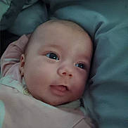 Jojo is registered to the contest to win money with this photo: baby, infant, child, portrait, face, eyes, sleepy, lying_down, blanket, clothing, pink, cozy, indoors, couch, soft_furnishings, close_up, photograph, gazing, baby_clothing, home