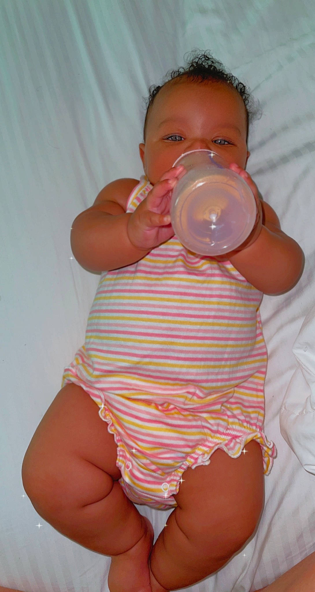 Tamyah is registered to the contest to win money with this photo: arm, baby_bottle, baby_toddler_clothing, cheek, chest, drinkware, finger, hand, head, human_body, joint, leg, lip, mouth, neck, person, pink, plastic_bottle, skin, stomach