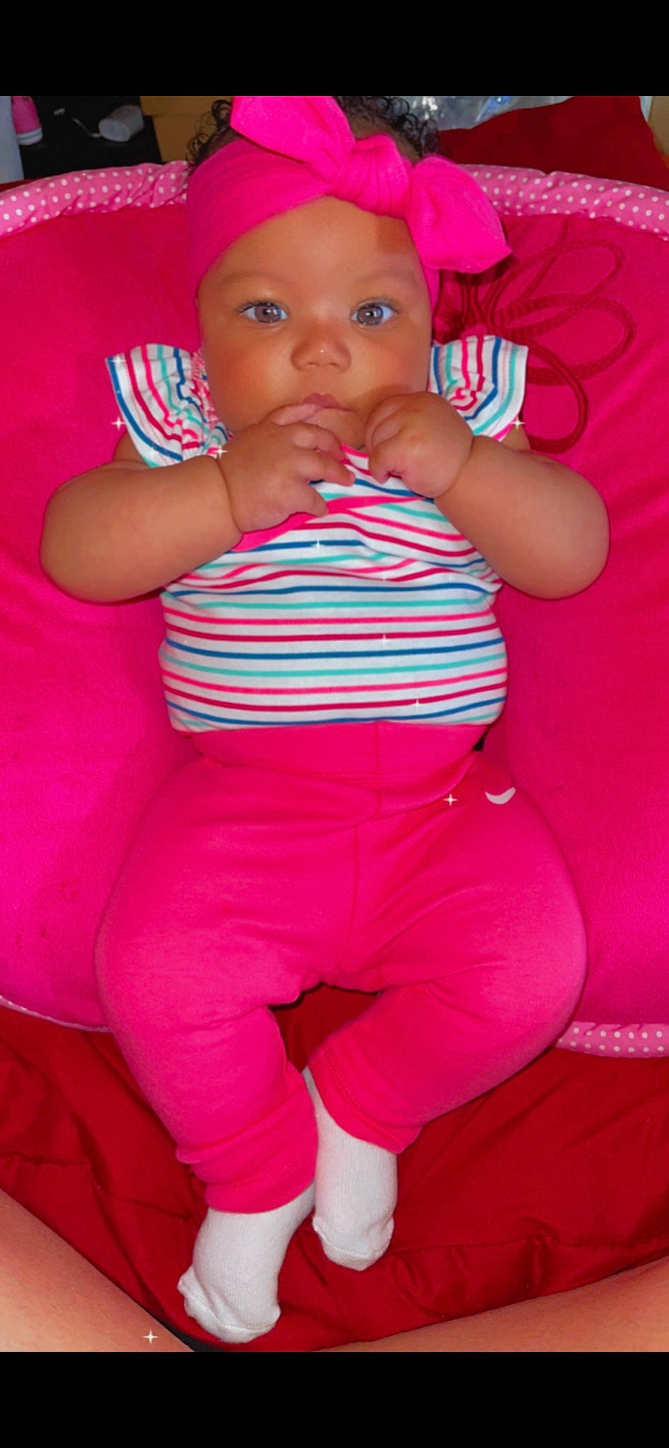 Tamyah is registered to the contest to win money with this photo: baby, baby_toddler_clothing, cheek, comfort, finger, gesture, hand, happy, headwear, human_body, joint, leg, lip, mouth, person, pink, red, skin, standing, textile